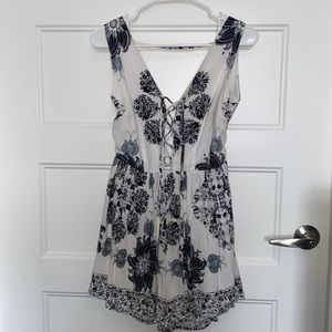 Medium, patterned romper with open back and laced front